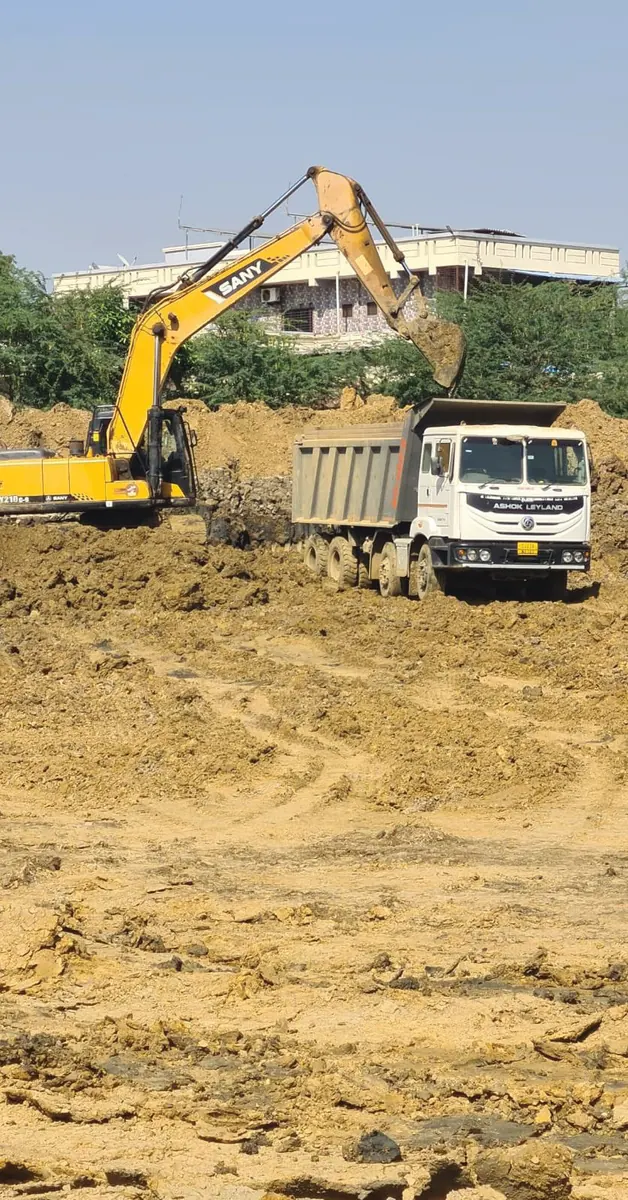 Excavator loading tipper at excavation site